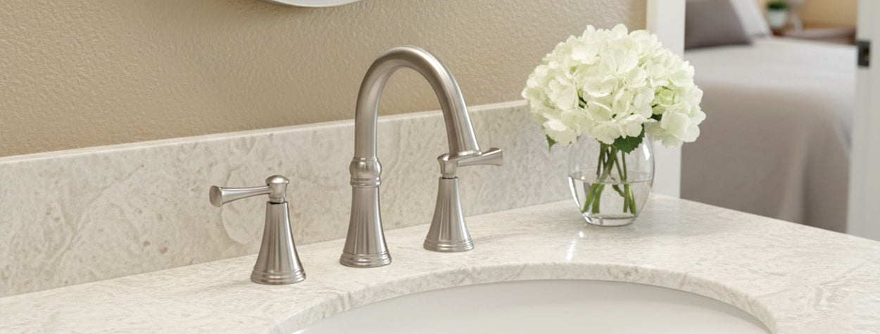 Woodbury faucet and decorative flowers on a countertop